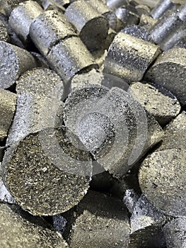 Close up view of compressed aluminium turnings called briquettes or pucks.