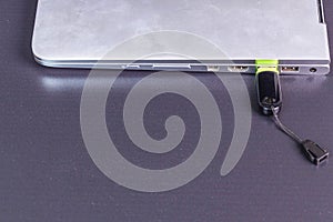 Close up view of  connecting  usb flash drive  to silver notebook computer