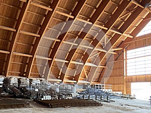 Close-up view of the connection of metal and wooden beams. Steel roof frame under construction. The interior of a big industrial