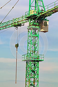 Close up view of a construction crane against blue sky. The metal element to the tower crane. Construction site