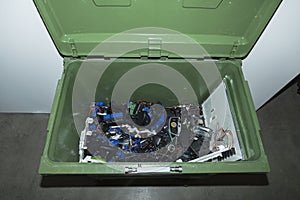 Close up view of container with electronics waste gathering for recycling.