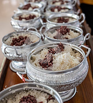 Close-up view of cooked rice packed in various aluminum pots