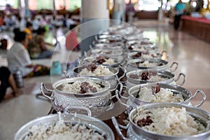 Close-up view of cooked rice packed in various aluminum pots