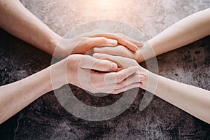 Close up view of couple holding hands, loving caring man supporting woman, giving psychological support