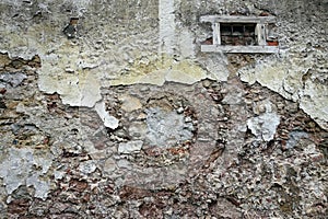 Close up view of crumbling plaster brick wall