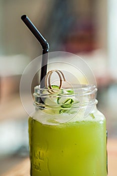 A close-up view of cucumber and lemon juice on a wooden table