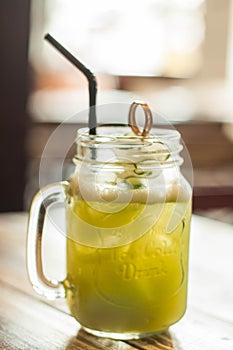 A close-up view of cucumber and lemon juice on a wooden table