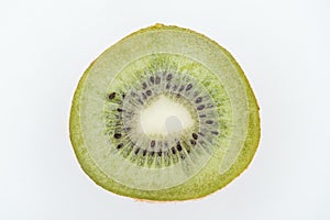 Close up view of cut fresh nutritious green kiwi with seeds isolated on white.