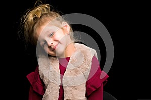 Close Up View of Cute Smiling Blonde Girl Posing on Black Background.