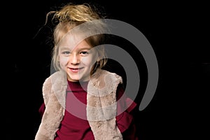 Close Up View of Cute Smiling Blonde Girl Posing on Black Background.