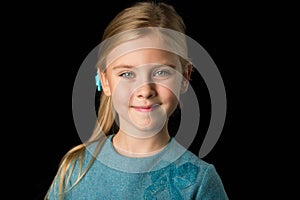 Close Up View of Cute Smiling Blonde Girl Posing on Black Background