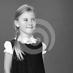 Close up view of cute smiling blonde girl posing.Black white photo