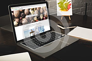 close-up view of designer workplace with notebooks and laptop with depositphotos website