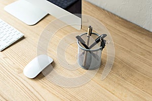close-up view of desktop computer, keyboard, computer mouse and office supplies