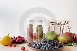 close up view of detox drinks, time to detox card and organic food