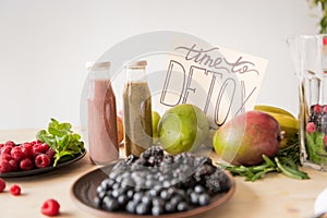 close up view of detox drinks, time to detox card and organic food