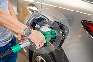 Close up view of driver hand fills up expensive gasoline in self-service filling station in Europe