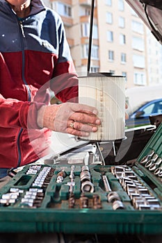 Close up view at driver hands with new clean air filter cartridge, self replacing without any motor-service