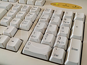 Close-up view of a dusty computer peripheral or hardware, detail from the keyboard, numbers on the buttons on the numeric part
