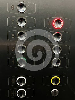 Close-up view of elevator control panel with illuminated buttons