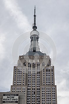 Close-up view of the Empire state building on a cloudy sky background