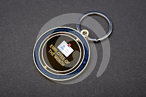 Close up view of employee of the month badge and Keychains with copy space