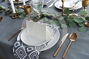 close up view of empty card on plates on tabletop with beautiful rustic setting for guests