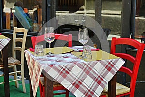 Close up view of empty quaint little restaurant with tables set on the sidewalk