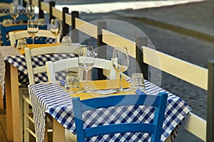 Close up view of empty quaint little restaurant with tables set on the sidewalk