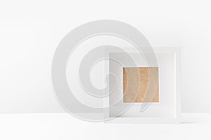 close-up view of empty white photo frame on white photo