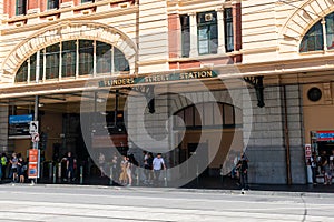 Close-up view of the entrance of Flinders street station with the name written and people in Melbourne Victoria Australia