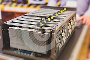 Close-up view of equipment for bitcoin cryptocurrency mining farm, electronic devices with fans, concept of mining technology