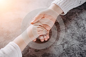 Close up view of family holding hands, loving caring mother supporting child. Helping hand and hope concept