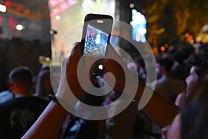 Close up view of female hands taking a video with smartphone