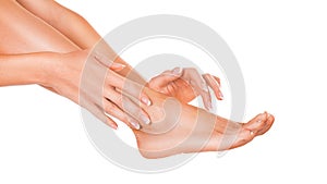 Close up view of a female leg and hands. Skin care and varicose prophylaxis concept