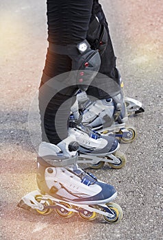 Close-up view of female legs and male legs in roller blades