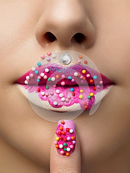 Close up view of female lips with sweet donut makeup