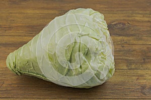 Close up view of field cabbage isolated on wooden background.