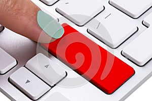 Close up view of a Finger Pushing on a red Button of computer Keyboard. Finger Pressing a Slim Aluminum Keyboard Button. Empty