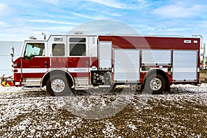 Close up view of a Fire Truck in the snow against a blue sky.