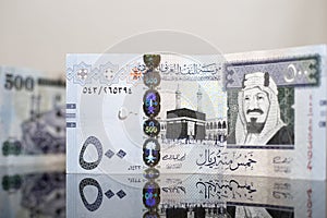 Close-up view of five hundred Saudi Riyal on a dark glass photo