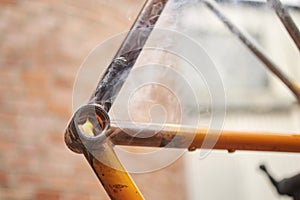 Close-up view of a flame from a torch used to remove paint from a bicycle frame
