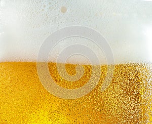 Close up view of floating bubbles in light beer texture