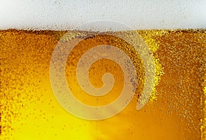 Close up view of floating bubbles in light beer texture