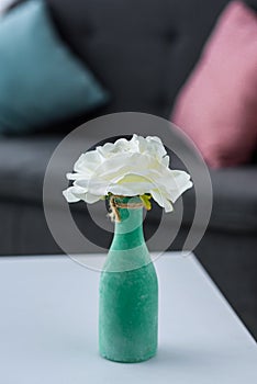 close up view of flower in vase on coffee table