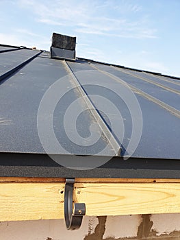 close up view of folded roof of house under construction with holders for gutters water drainage system