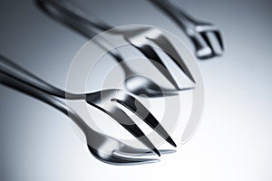 close-up view of forks with two tines reflected