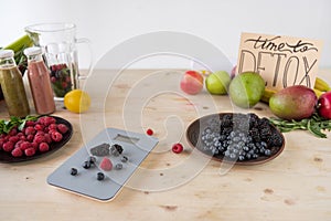 close up view of fresh berries, fruits and time to detox card