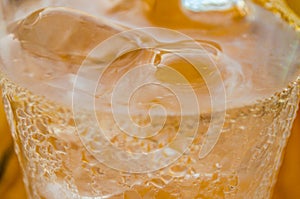 Close Up View of a Fresh Cold Soda Beverage in a Glass with Ice Cubes. Liquid Abstract Background. Macro Photography.