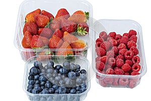 Close up view of fresh colorful blueberry, raspberry and strawberry isolated on white background.